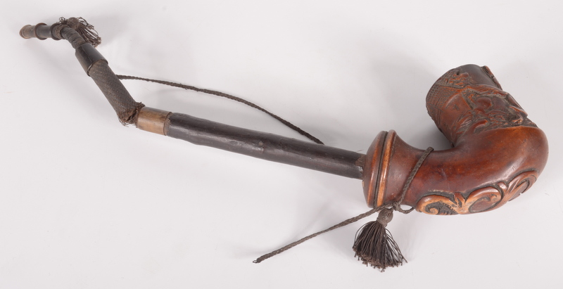 A wooden pipe, possibly Swiss, carved with a house and a dog and dated 1822, height 11cm.