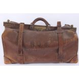 A brown leather Gladstone bag, inscribed N.J.S., height 35cm, length 69cm, width 38cm.