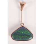 A triangular black opal in pendant mount. Condition report: Single opal.