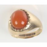 A carnelian cabochon ring set in 9ct. gold, size N.