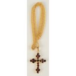 A 9ct gold garnet set cross on 9ct gold chain, 4.5g.