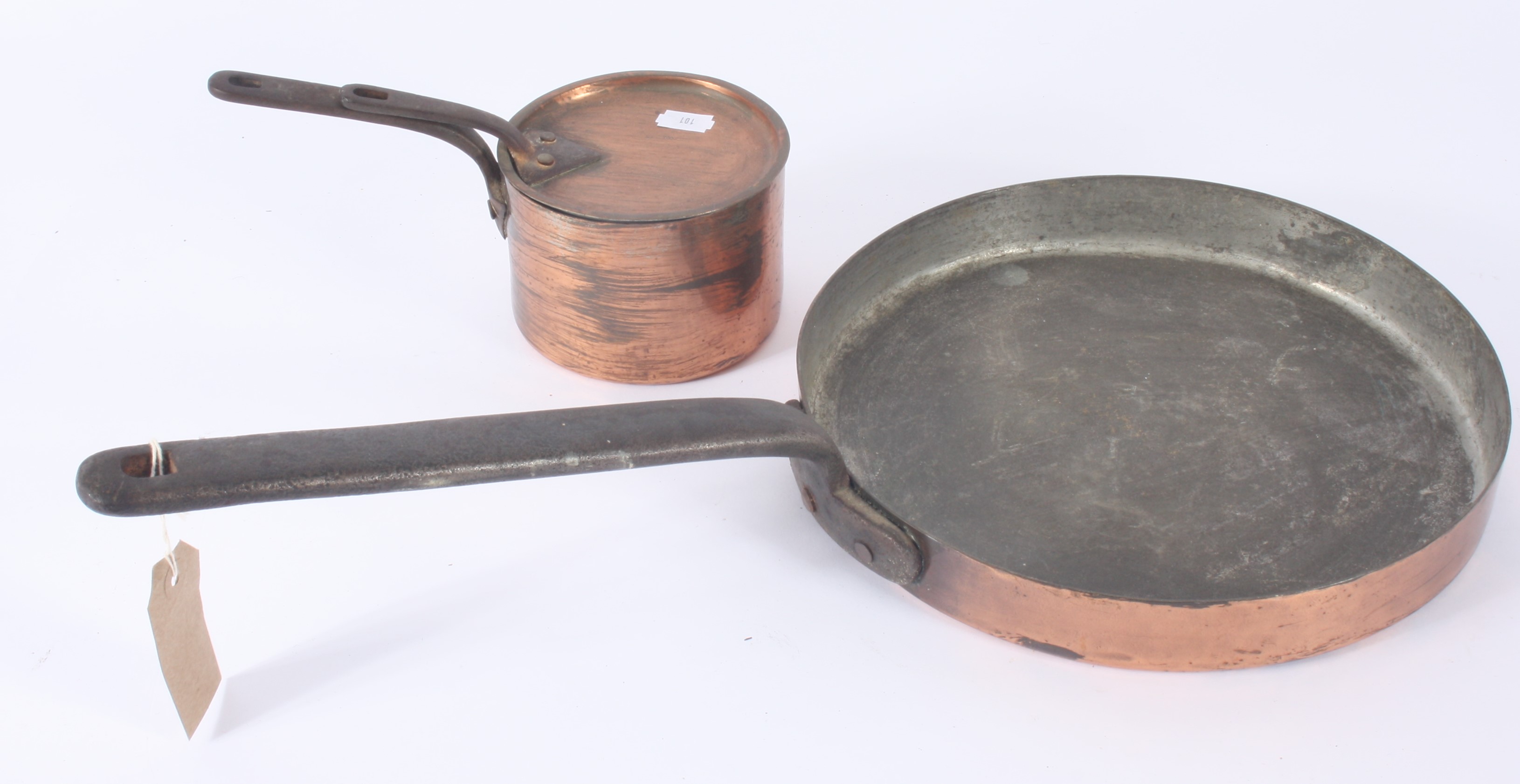 Two copper pans, each with cast iron handle, length of largest 56.5cm, diameter 28.2cm.