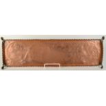 An Arts and Crafts copper rectangular tray decorated with stylised birds, length 68cm, width 21.5cm.