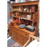 A George III style oak dresser, 20th century, the rack with two shelves and three small cupboards,