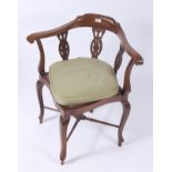 An Edwardian mahogany inlaid corner armchair, with a triple pierced splat with a rattan seat,