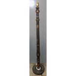 A black japanned standard lamp, the turned column with gilt floral sprays and an exotic bird,