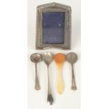 A miniature silver mounted photograph frame, three silver salt spoons and a bone salt spoon.
