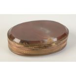 A gilt metal oval snuff box with agate lid and base.