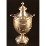 A George IV tea caddy of urn form, the lid with ball finial,