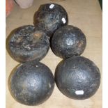 Five iron 6" cannon balls on a wooden garland.