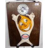 An aneroid barometer advertising Esso.