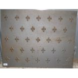 A fleur de lis cast iron fireback, height 55cm, width 70cm.