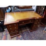 A mahogany pedestal desk, circa 1900, the inverted breakfront top with a leather inset,