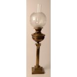 A Victorian brass oil lamp, with glass shade.