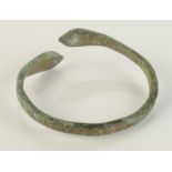 A Roman bronze snake head bracelet.