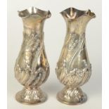 A pair of late Victorian Rococo bellied silver vases in French taste by Sibray, Hall & Co,