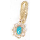 A gold mounted turquoise pendant on 9ct gold chain.