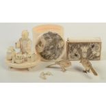 A Japanese carved ivory box, 19th century, the cover depicting a roaring lion, height 7cm,