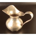 An Italian 800 standard silver pitcher the body hammered, the strap handle also hammered,