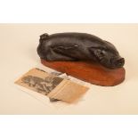 A carved wood sculpture of a pig, by Edward 'Ted' Roocroft,