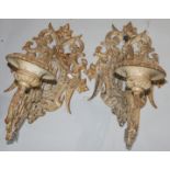A pair of cast iron, white painted, wall mounted candle sconces, height 56cm, width 36cm,