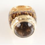 A 14ct gold ring by Genero Italy with enamelled shank and topaz within a chased rubbed setting.