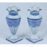A pair of Swansea oval section blue and white moulded vases, each with a lozenge section foot,