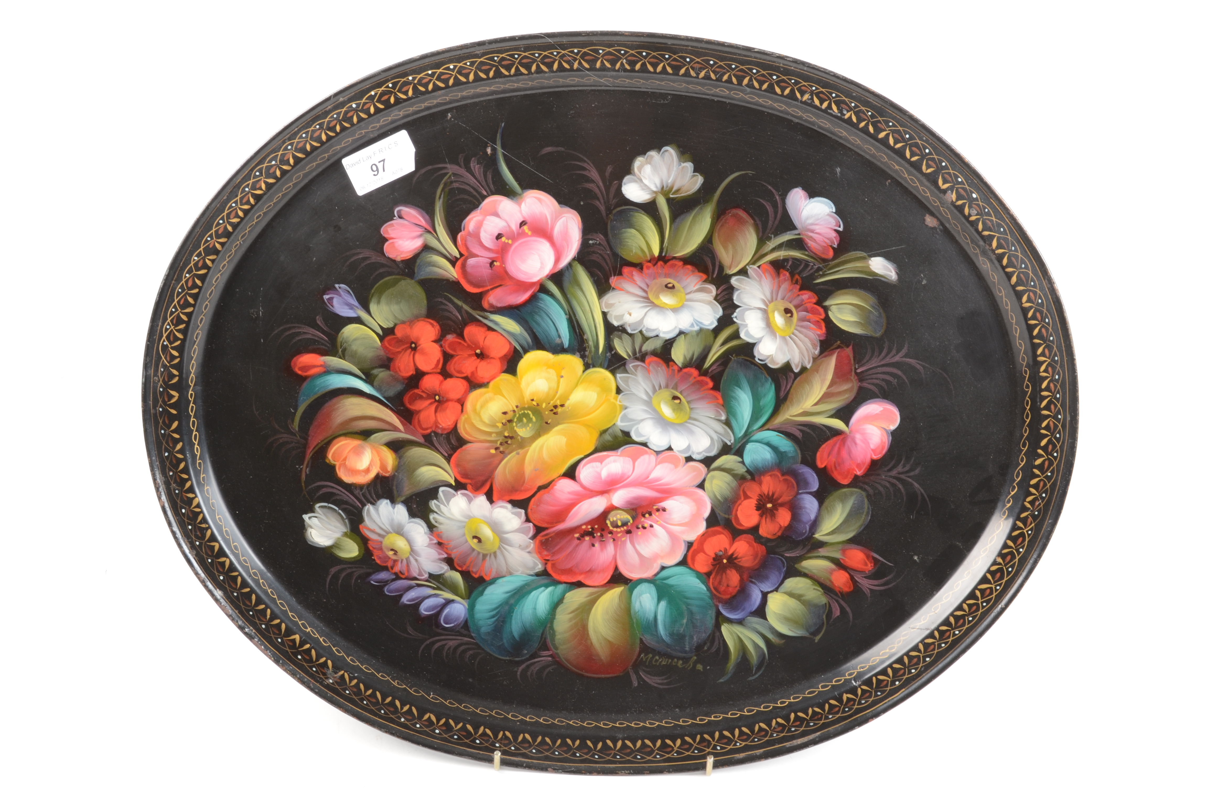 A tole peinte oval tray, painted with flowers and signed M.Ciuiceh?, 40.5 x 50.5cm.