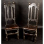 A pair of William III dark oak high back joined chairs, with acorn finials.