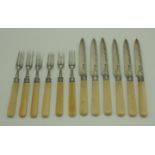An Edwardian set of six silver fruit knives and forks with floral engraved silver blades and bone