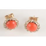 A pair of red coral and diamond earrings,