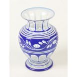 A bohemian blue and white enamelled glass vase, of baluster form, decorated with stylised leaves,
