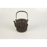 A Japanese iron kettle, 19th century, with a swing handle, the body decorated with crabs,