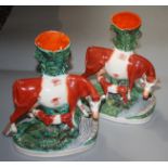 A pair of Victorian Staffordshire cow and calf spill groups, height 27.35cm.