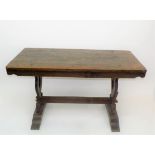 An oak refectory style table, the rectangular top on pierced end supports,