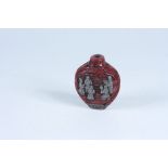 A cinnabar and silvered snuff bottle, height 6.5cm.