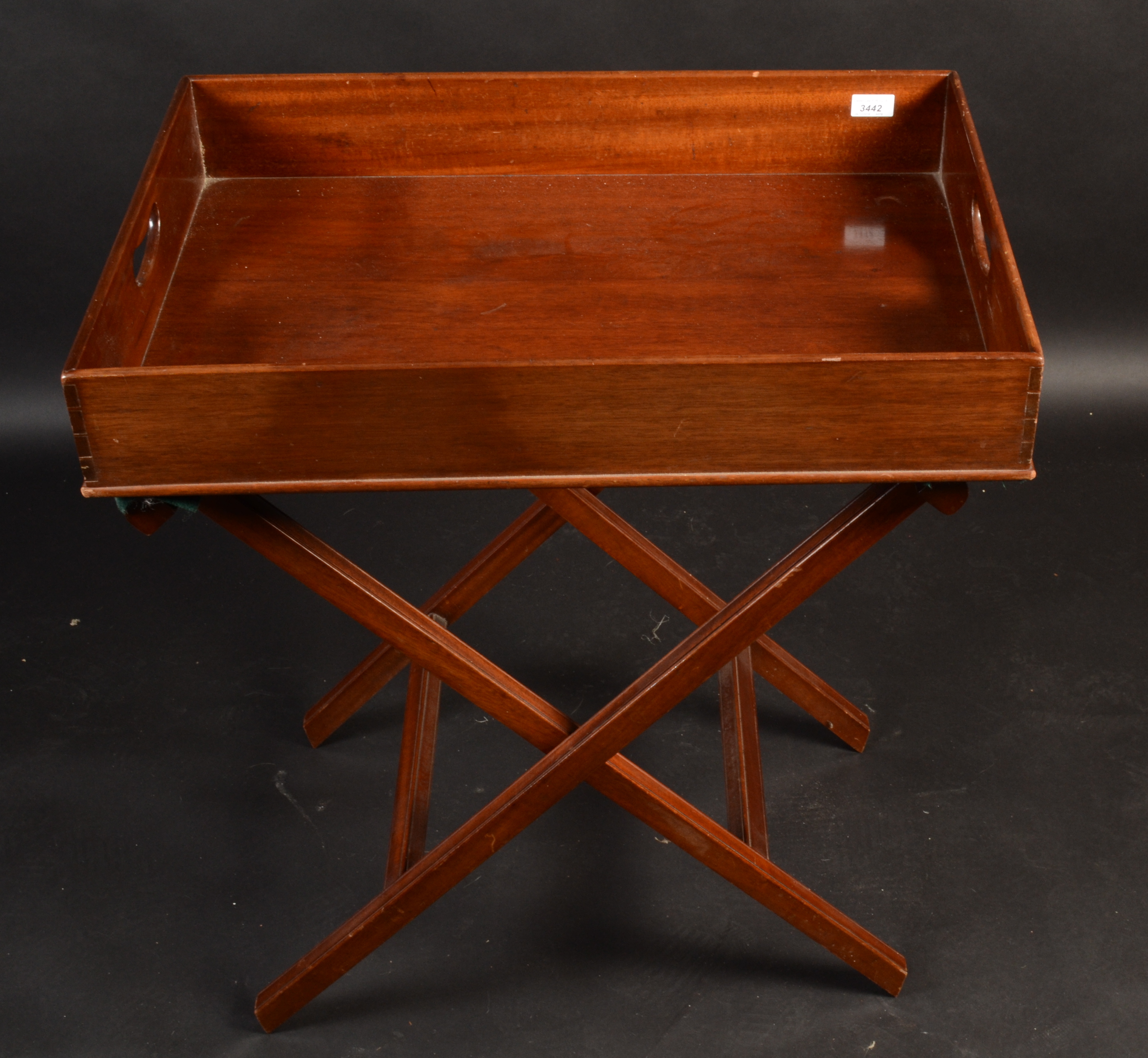 A mahogany butler's tray on folding stand, 20th century, height of tray 11cm, width 70cm, depth 48.