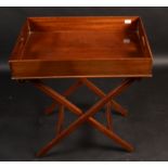 A mahogany butler's tray on folding stand, 20th century, height of tray 11cm, width 70cm, depth 48.