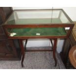 A mahogany glazed display case, early 20th century, with splay legs joined by a cross stretcher,