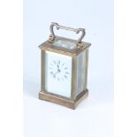 A brass carriage clock, height 11.3cm, width 8cm, depth 6cm.