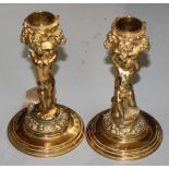 A pair of gilt metal candlesticks signed F.