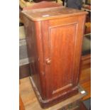 A Victorian mahogany bedside cabinet, with a single panelled door enclosing two shelves,