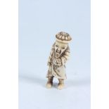 A stag horn netsuke carved as a man, height 5.9cm.