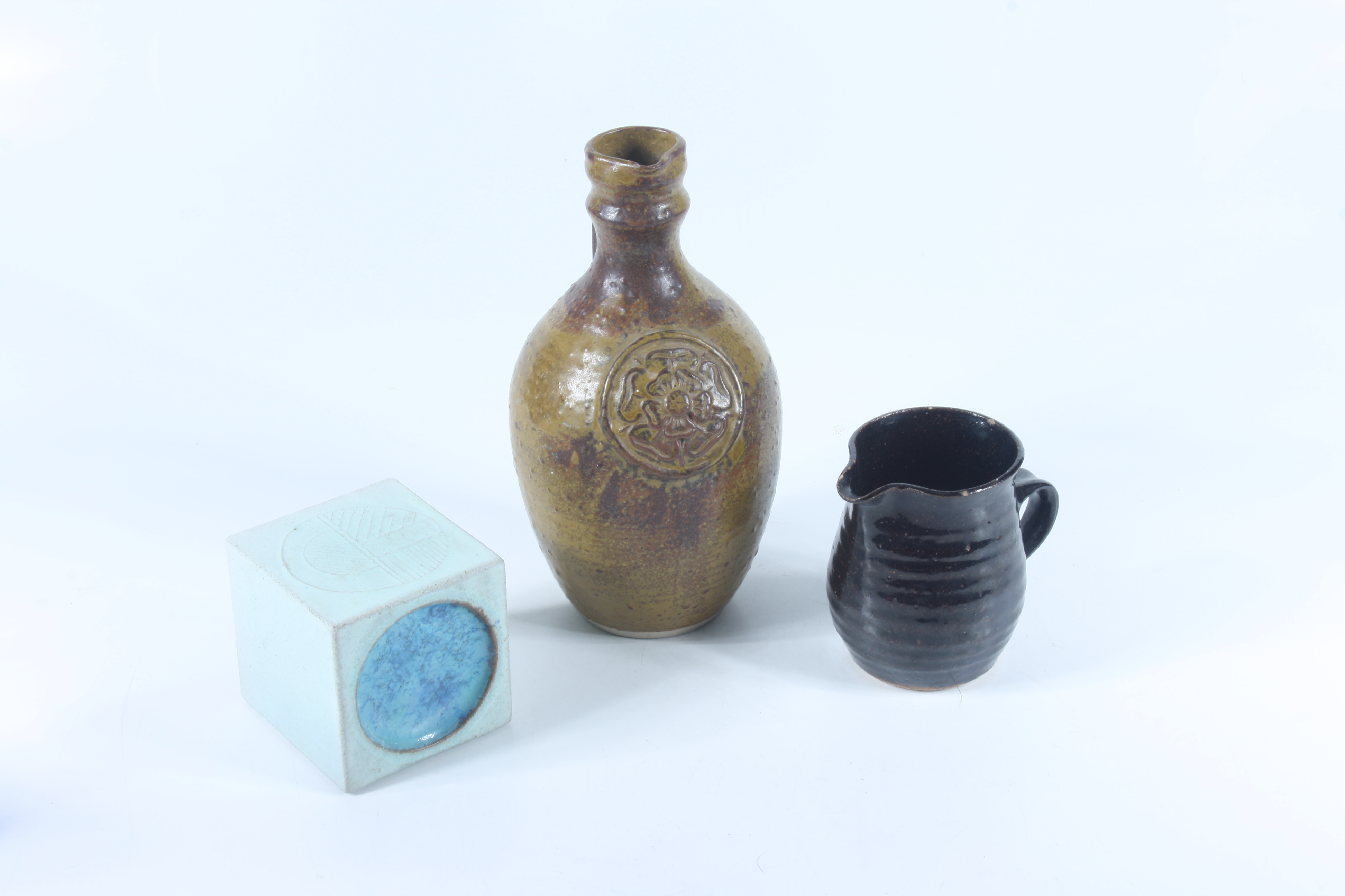 A tenmoku glazed studio pottery jug, with seal and two other studio pottery items.