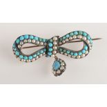 A Victorian gold and silver bow brooch set with turquoise and pearls with a teardrop shaped drop.