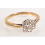 An 18ct gold ring set a flower head diamond cluster.