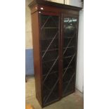 A mahogany glazed bookcase, 19th century, the dentil cornice above a pair of astragal glazed doors,