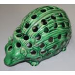 A Wedgwood majolica green glazed pottery model of a hedgehog, height 14cm, length 27cm.