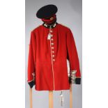 A Grenadier Guard's uniform, tunic size 32, trouser size 25 and peaked cap size 57,