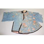 A Chinese blue silk robe, embroidered with floral sprays and stylized moths, length 104cm.